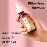 Hand holding the filler-free Corvasse oil bottle that reduces hair growth in weeks
